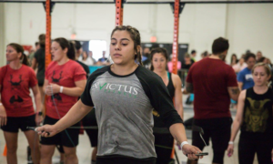 Female athlete warms up with double-under before a weightlifting event.