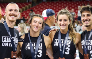 2022 Team Invictus posing with their 3rd place medals around their necks.