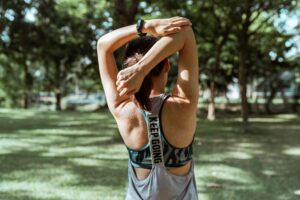 Girl stretching in the park wondering if she is too sore