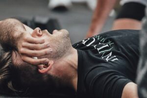 athlete laying on the ground post quarterfinals workout