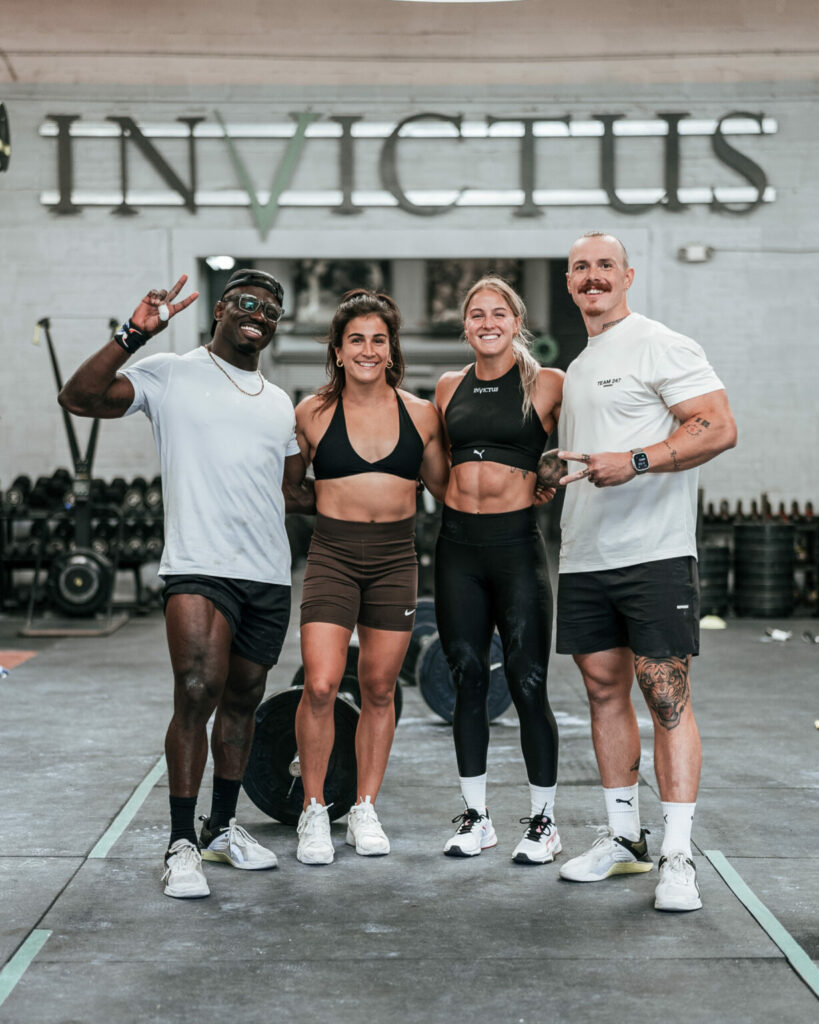 Team Invictus athletes standing together in the gym. 